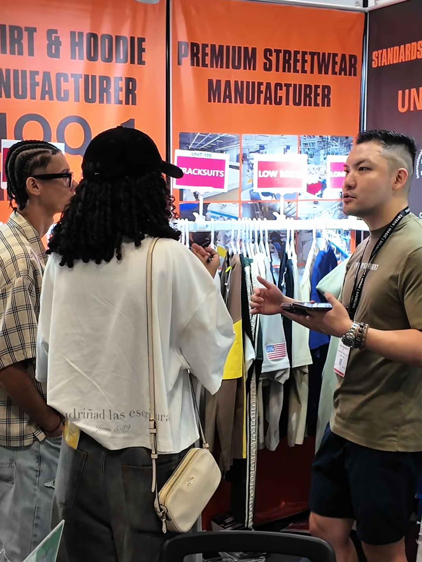 Customers reviewing apparel samples with the UNIT-100 team in New York
