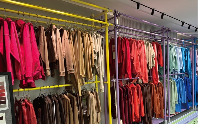 Rails of plain stock hoodies and sweatshirts in many colors